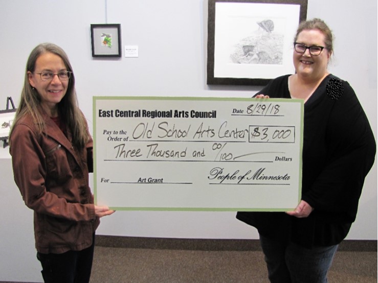 Image of ECRAC's Executive Director awarding a check for general operations