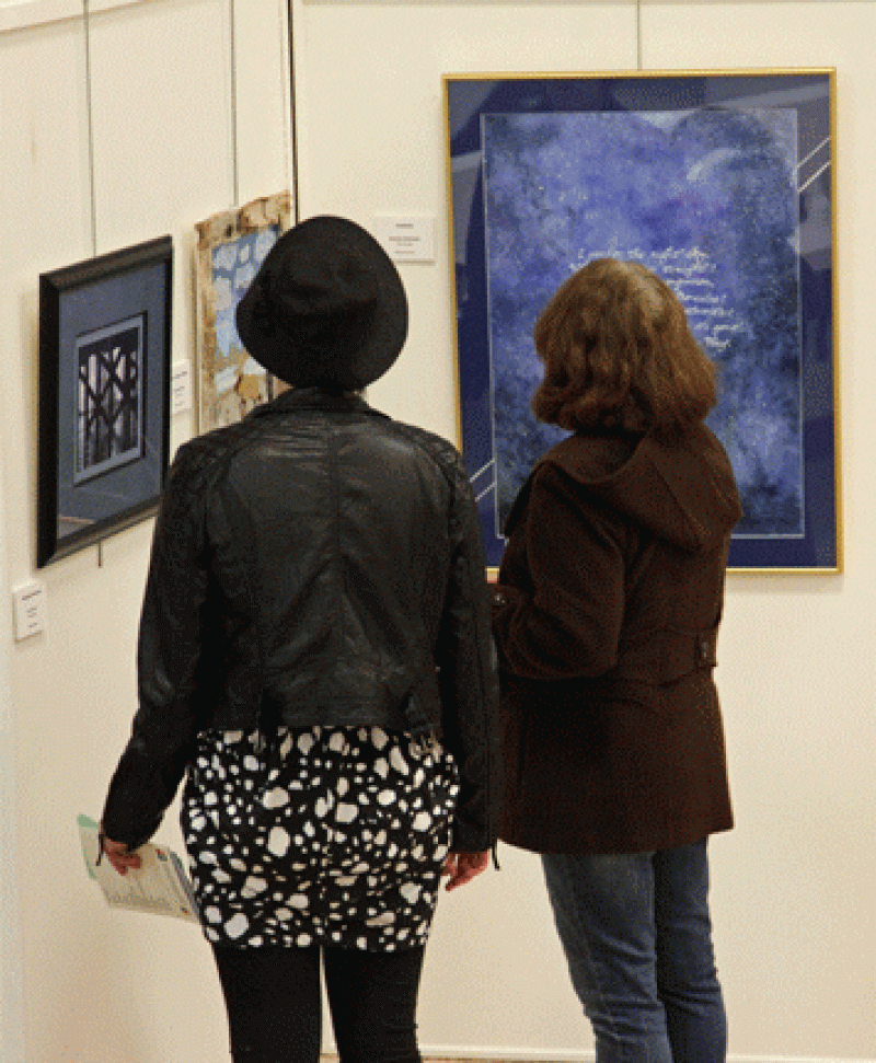 Attendees enjoying the artwork at the IMAGE Art Show 2013.